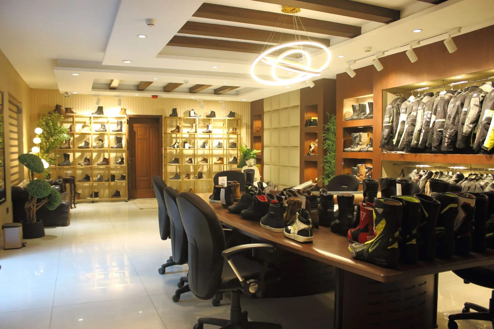 Motorcycle footwear and apparel display in the ELEONE showroom — motorcycle gear catalogue