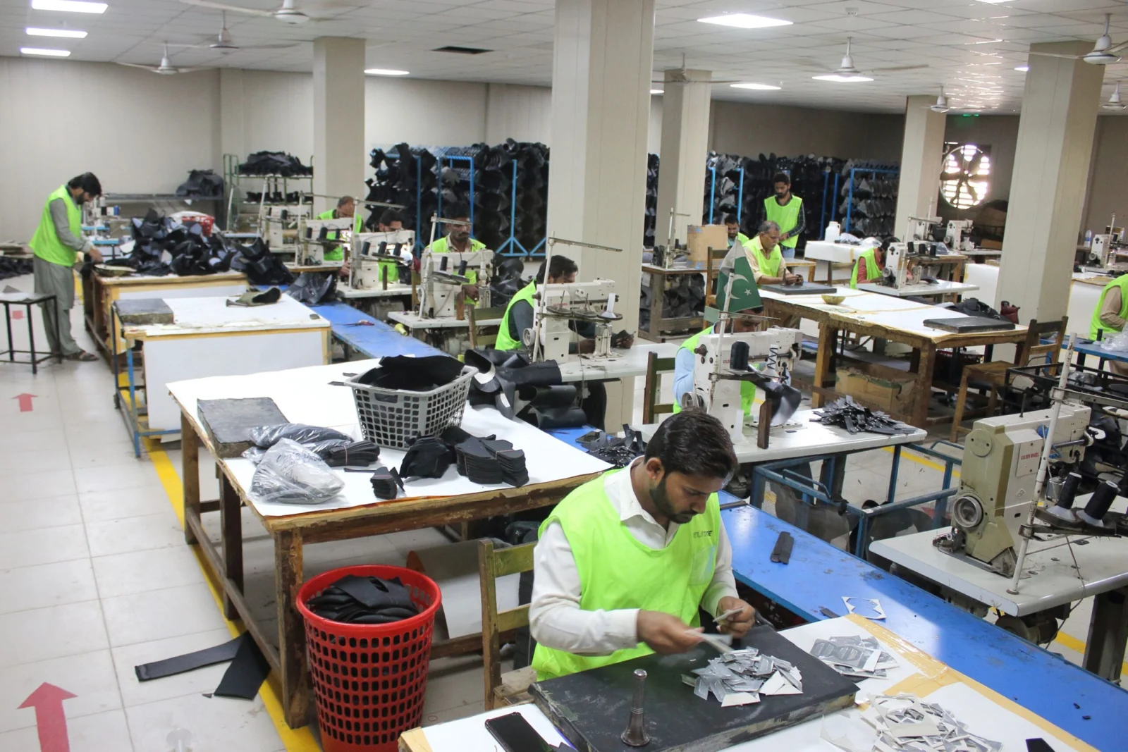 Motorcycle gear production worktables and footwear sewing stations