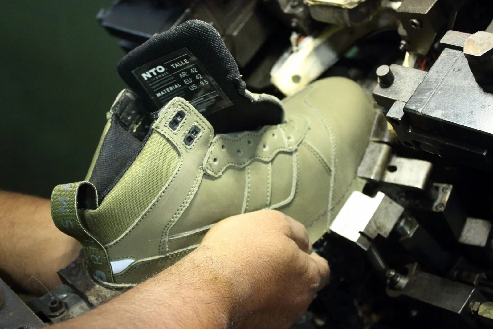 Close-up of an olive-coloured boot during production